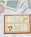 Premium Solid Wood Desktop Jewelry Organizer Tray With Divided Grid Compartments For Rings Necklaces Earrings And Watches Durable Storage Holder displaying earrings and rings in segmented compartments.