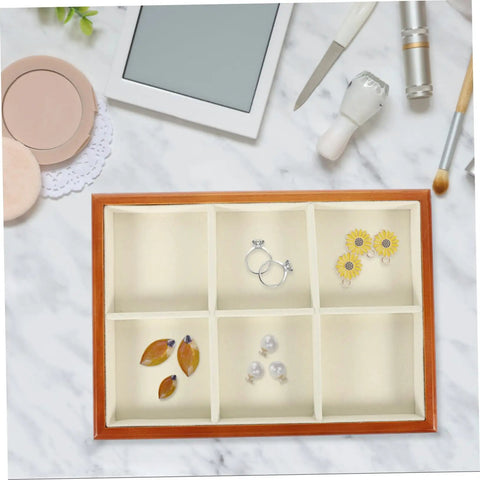 Premium Solid Wood Desktop Jewelry Organizer Tray With Divided Grid Compartments For Rings Necklaces Earrings And Watches Durable Storage Holder displaying earrings and rings in segmented compartments.