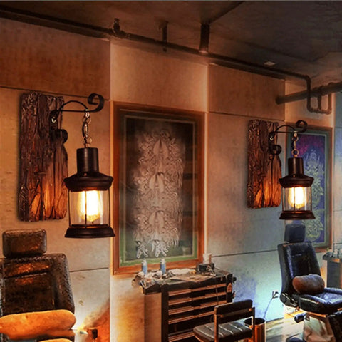 Top Shelf Rustic Wall Sconce Featuring Solid Wood Backplate And Vintage Industrial Metal Lantern Design, lit, in stylish interior.