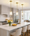 Straight Up Three Pack Brushed Gold Crystal Pendant Lights For Kitchen Islands, elegant mini chandeliers above a kitchen island.