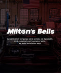 Interior view with "Milton's Bells" signage in auto workshop showcasing service bell and alarm systems installation.