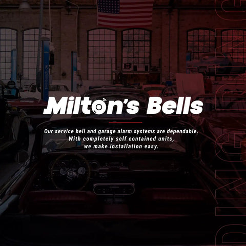 Interior view with "Milton's Bells" signage in auto workshop showcasing service bell and alarm systems installation.