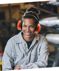 Heavy Duty Hearing Protection Earmuffs Built To Crush Nasty Workshop And Factory Noise Solid Sound Insulation Headband in use by a smiling worker.