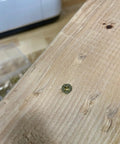 Close-up of a flat head Phillips drive screw in wood, representing The Real Deal 140 Piece Wood Screws Assortment Kit.
