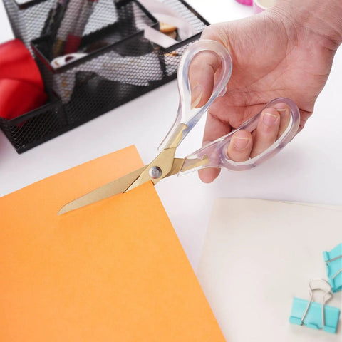 Acrylic Scissors Set With Titanium Gold Coated Blades For All-Purpose Heavy-Duty Office Desk Scissors With Clear Comfort-Grip Handles on orange paper