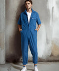 Mens Short Sleeve Coveralls Shop Grade Mechanic Jumpsuit With Deep Utility Pockets Rugged Cotton Poly Blend Built Different For Summer Work Grind Crew Rig Gear on model in blue color.