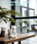 Decorative Sharp Ceramic Toilet Bolt Caps 2 Pack White Cat Design resting on a wooden table with plants.