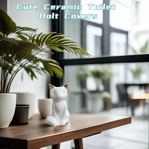 Decorative Sharp Ceramic Toilet Bolt Caps 2 Pack White Cat Design resting on a wooden table with plants.