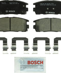 Bosch BC1275 rear ceramic brake pad set; four pads with mounting hardware clips and a lubricant packet.