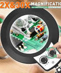 Pro Grade 12X 30X Magnifying Glass With Light And Stand showing electronics soldering under magnification with adjustable controls.