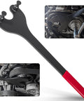 Side view of cam pulley holding tool with black steel arm and red handle; two-pin end for locking camshafts during timing belt work.