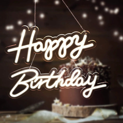 Lit Happy Birthday Neon Sign LED Light For Wall Backdrop Decoration With Split Design Reusable Approximately Forty Inch Total Length White Neon For Parties And Events glowing in front of a cake