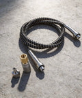 Heavy Duty High Pressure Air Hose With 9000 PSI Rating And Stainless Steel Braid on concrete with quick connect couplers.