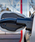 Unlock Access To Over Twenty Five Thousand Tesla Superchargers With This Hella Compatible NACS To CCS Electric Vehicle Adapter Delivering Five Hundred Amps One Thousand Volts For Serious Fast Charging On Your Next Road Trip, showcasing a black charging connector on a vehicle.