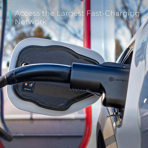 Unlock Access To Over Twenty Five Thousand Tesla Superchargers With This Hella Compatible NACS To CCS Electric Vehicle Adapter Delivering Five Hundred Amps One Thousand Volts For Serious Fast Charging On Your Next Road Trip, showcasing a black charging connector on a vehicle.