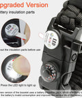 Close-up of 20 In 1 Paracord Survival Bracelet with SOS LED light, compass and fire starter features, battery insulation detail.