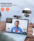 Top Shelf 4K Webcam Packs Sony Autofocus Sensor To Drop Crisp 8MP Video Built In Dual Mic And Quick Slide Privacy Shield shown on laptop during video call.