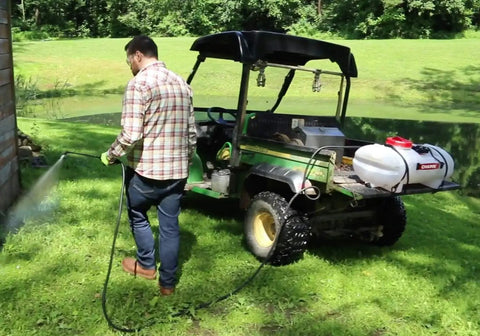 Man spraying lawn with 15 Gallon ATV UTV Spot Sprayer With 18 Inch Spray Wand, 12 Volt Diaphragm Pump, Filtration System, EZ Mount Quick Connect, No Shaft Or Seal Replacements, Translucent White Poly Tank For Lawn Care And Chemical Mixing
