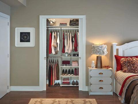 Maximizer Closet Organizer Add On Unit With Four Shelves And Double Hang Rod installed in bedroom closet, holding clothes and shoes.