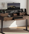 Built Tough 55 Inch Electric Adjustable Standing Desk Featuring Five Roomy Storage Drawers And Raised Monitor Platform Smooth Glide Motor Custom Memory Buttons Boss Home Office Setup with gaming console and monitor.