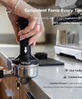 Person using 54mm Espresso Tamper With Adjustable 20 To 30 Lb Dial Audible Click Feedback in kitchen scene.