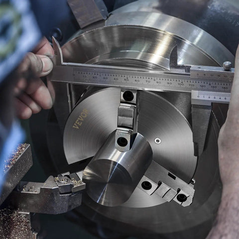 Close-up of a Three Jaw Self Centering Lathe Chuck 10 Inch With 0.24 To 9.84 In Clamping Range being measured with calipers.