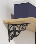 Heavy Duty Decorative Shelf Bracket For Wall Mounts supporting a wooden shelf with a black metal design, ideal for cafes and kitchens.
