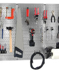 4-Foot Metal Pegboard Tool Organizer Kit with galvanized toolboard and black accessories in garage setup with various tools mounted