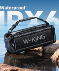90W Peak Portable Bluetooth Speaker With Beastly Bass Subwoofers And Punchy HD Sound, IPX6 Waterproof on rocks by water