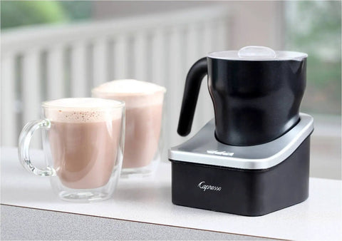 Automatic Milk Frother And Hot Chocolate Maker For Barista Level Foam At Home With 8 Oz Frothing Capacity And 12 Oz Heating Dishwasher Safe Removable Milk Pitcher With Clear Lid Great For Lattes Cappuccinos And Mochas next to two cups of frothed milk