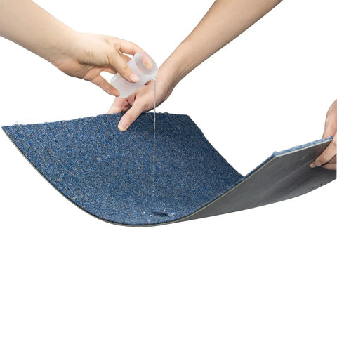 Demonstration of water-resistant property of 20 Pack 20x20 Inch Carpet Tiles With Stickers, Reusable, PVC Backed, Blue.
