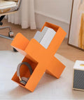 Dope Geometric Iron Floor Bookshelf With Nordic Vibe in orange, multi angle metal organizer with books and headphones visible.