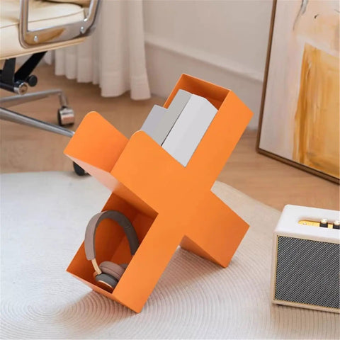 Dope Geometric Iron Floor Bookshelf With Nordic Vibe in orange, multi angle metal organizer with books and headphones visible.