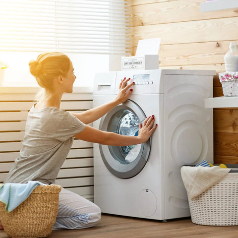 Woman using washer with Slick Clear Dryer Sheet Holder With Lid Fabric Softener Dispenser For Laundry Room Decor on top