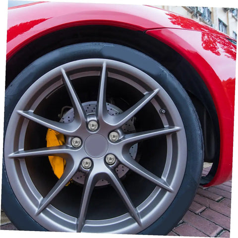 Close-up of alloy wheel on red vehicle with lug nut screws for ATV go kart and outdoor racing no hassle install wheel fasteners