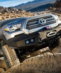 Toyota truck navigating rugged terrain in desert landscape