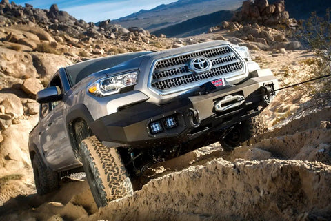 Toyota truck navigating rugged terrain in desert landscape