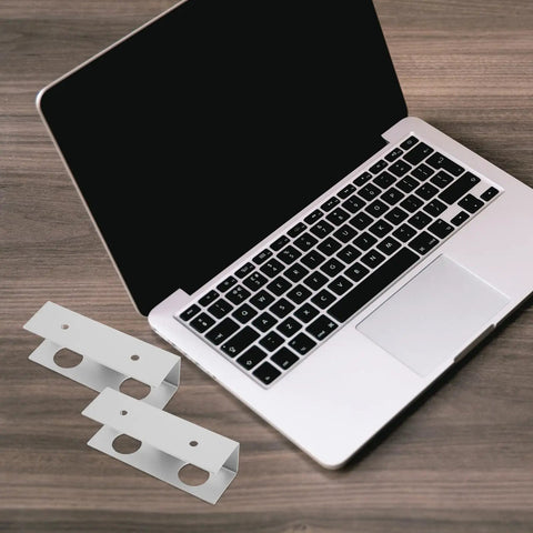 Heavy Duty Aluminum Under Desk Laptop Mount Bracket, Slick Silver Riser Lifter For Office Grind and Mobile Truck Rack, showing silver brackets beside laptop.