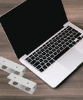 Rock Solid Aluminum Under Desk Laptop Mount With A Sleek Space Saving Design And Heavy Duty Support For Clean Home Office Setup and Straightforward Install With Sturdy Silver Brackets next to a silver laptop.