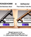 Comparison of 30 Pack Solid Stainless Steel Cabinet Handles and Drawer Pulls With Oil Rubbed Bronze Finish, showing weight difference