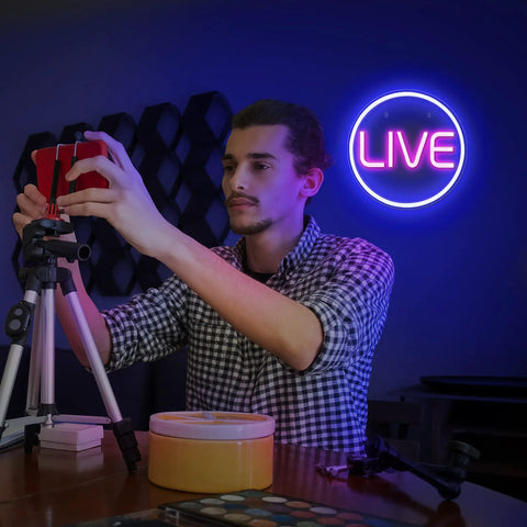 Streamer setting up in front of Blue And Pink LED On Air Neon Sign For Streamers Influencers And Gamers A Dope Live Streaming And Recording Light To Elevate Your Studio Setup Game Room And Bedroom Decor USB Powered Easy To Mount And Use