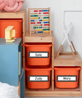 Orange bins in classroom with 36 Piece Composition Desk Name Plates For Classroom 9.5 By 3 Inch Black And White Reusable Name Tags.