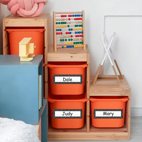 Orange bins in classroom with 36 Piece Composition Desk Name Plates For Classroom 9.5 By 3 Inch Black And White Reusable Name Tags.