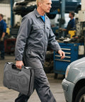 Mechanic carrying 108 Piece Workhorse Mechanic Socket Tool Kit With CR V Steel Sockets in a garage