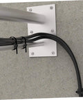 Heavy Duty Black Plastic Saddle Cable Tie Clips With Screw Fixing 100 Piece Kit for securing wires on a wall mount.