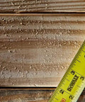 ToughSeries 35 Ft Tape Measure With Magnetic Hook double sided readout on wooden surface, emphasis on extended reach for pros and DIY projects.