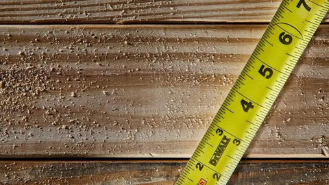 ToughSeries 35 Ft Tape Measure With Magnetic Hook double sided readout on wooden surface, emphasis on extended reach for pros and DIY projects.