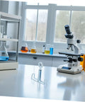 25 Piece Laboratory Rubber Tube Clamps for Flow Control on lab countertop with microscope and beakers in background