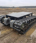 Heavy Duty Self Propelled Machinery Moving Dolly With Remote Control For Industrial Equipment Transport Workhorse Grade Skates on muddy terrain.