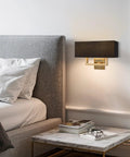 Sleek Mid Century Modern 16 Inch Two Light Wall Sconce In Cool Brass Gold Finish With Black Fabric Shade in bedroom interior